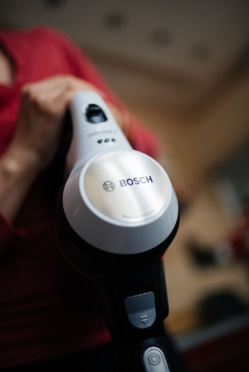 Cleaning with a cordless vacuum in a modern living room during afternoon light.jpg